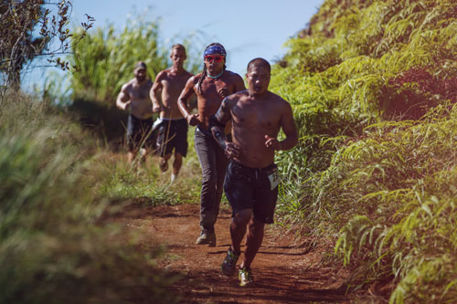 Ultimate Hawaiian Trail run participants running through cane fields